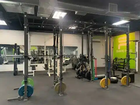 Functional training racks, free weights, and gym equipment at Shape Plus Denver