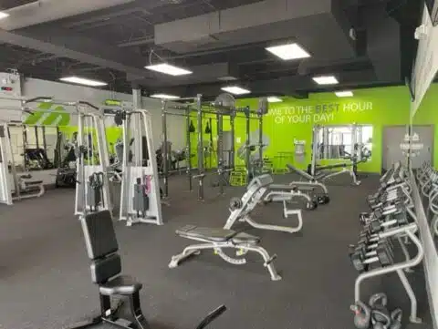 Main training area with benches, dumbbells, cable machines, and strength equipment at Shape Plus DTC